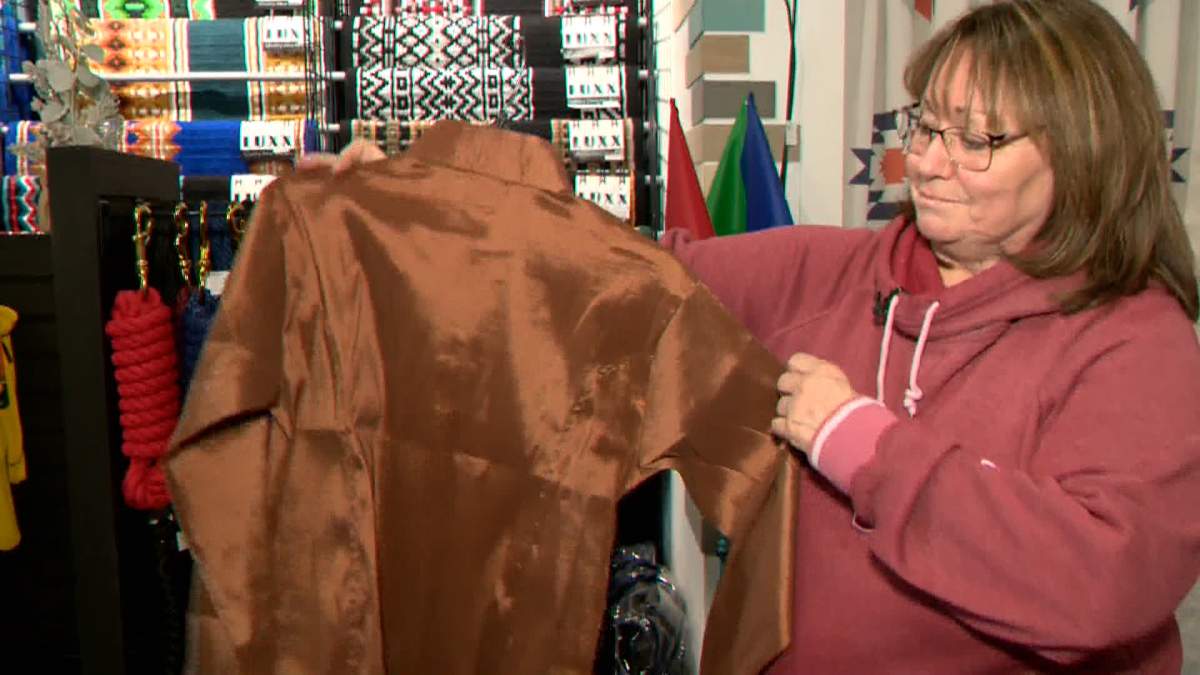 Beth Latwaitis owner of Ranch by Design, located in Lacombe, Alta., holds a "show shirt," similar to one she recently sold online to a customer in California.