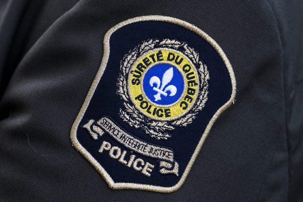 This Sûreté du Québec badge was photographed in Ottawa on Sept. 28, 2025. A woman is in critical condition following an altercation with a man that allegedly escalated on Sunday afternoon in Rougemont, in the Montérégie region. LA PRESSE CANADIENNE/Spencer Colby.