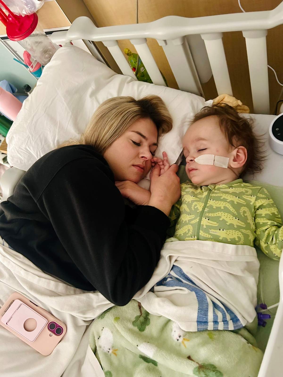 Celeste and Bodie take a quick nap together in a hospital bed.