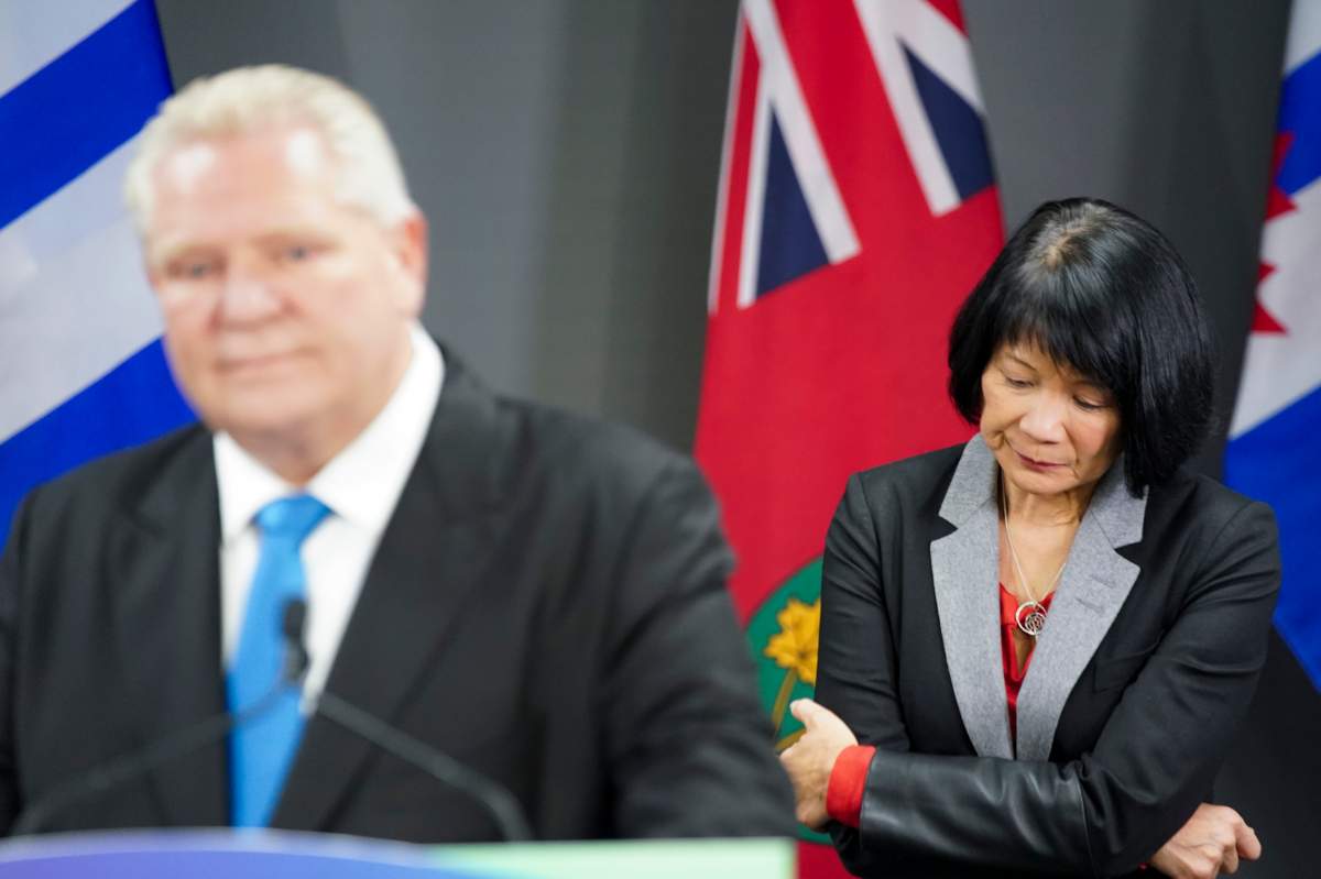 Ontario Premier Doug Ford, left, speaks during a press conference regarding housing development in the Greater Toronto Area, as Toronto Mayor Olivia Chow, right, looks on at Toronto City Hall, in Toronto on Thursday, Feb. 22, 2024. 
