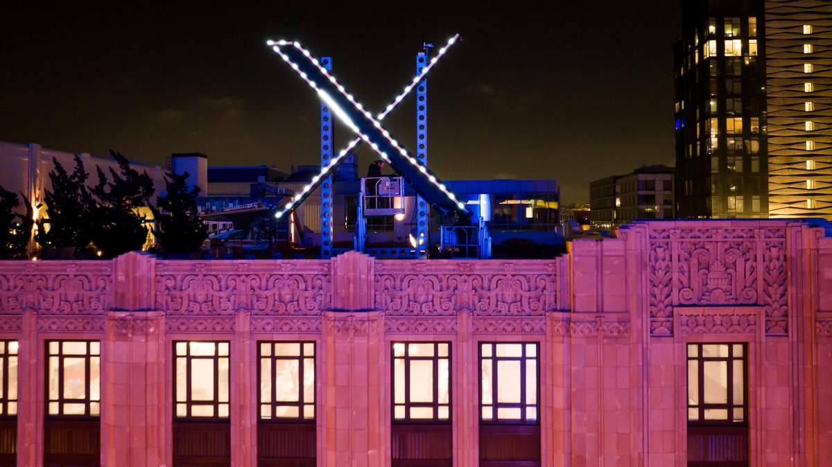 FILE - Workers install lighting on an "X" sign atop the company headquarters, formerly known as Twitter, in downtown San Francisco, July 28, 2023. (AP Photo/Noah Berger, File).