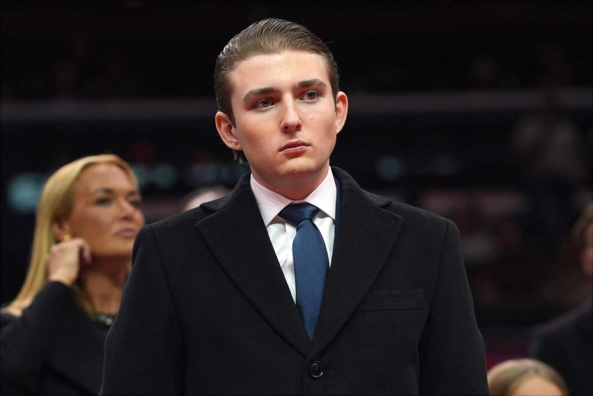 Barron Trump watches as his father, U.S. President Donald Trump, attends an indoor Presidential Inauguration parade event at Capital One Arena, Jan. 20, 2025, in Washington.