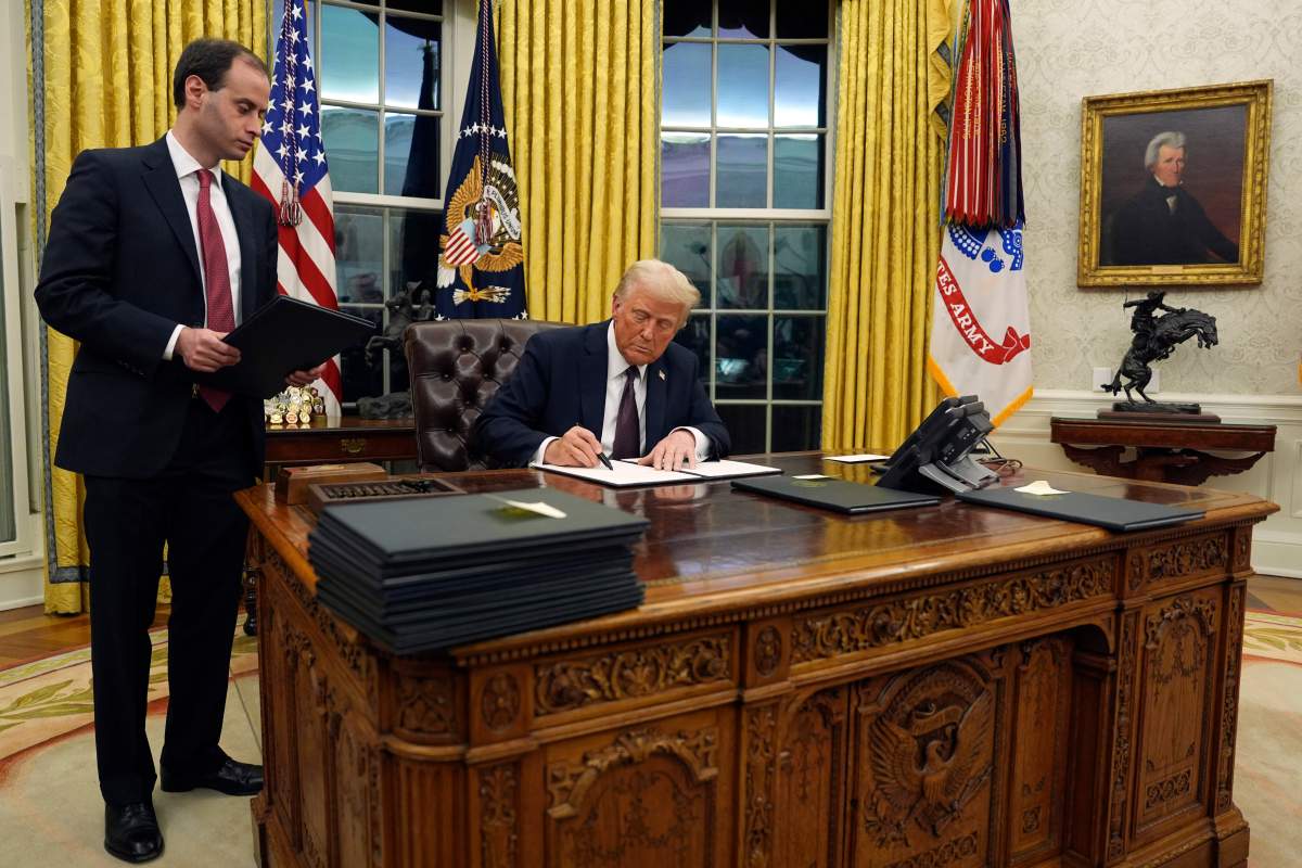 President Donald Trump signs an executive order withdrawing the U.S. from the World Health Organization in the Oval Office of the White House, Monday, Jan. 20, 2025, in Washington.