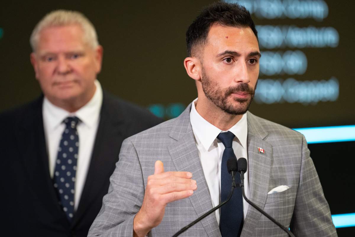 Stephen Lecce, minister of energy and mines of Ontario, speaks at a press conference as Ontario Premier Doug Ford looks on, in Toronto on Thursday, April 17, 2025.
