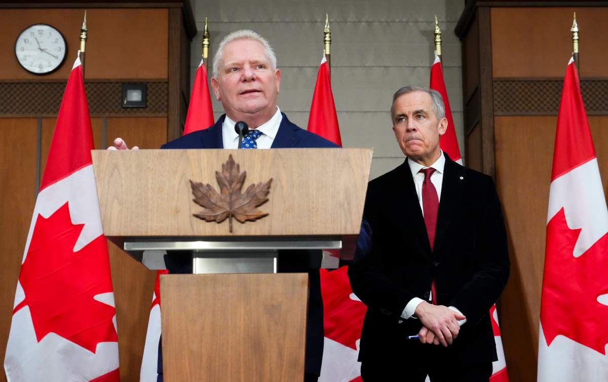 Ontario Premier Doug Ford speaks as Prime Minister Mark Carney, right, looks on during an announcement on Parliament Hill in Ottawa on Dec. 18, 2025.