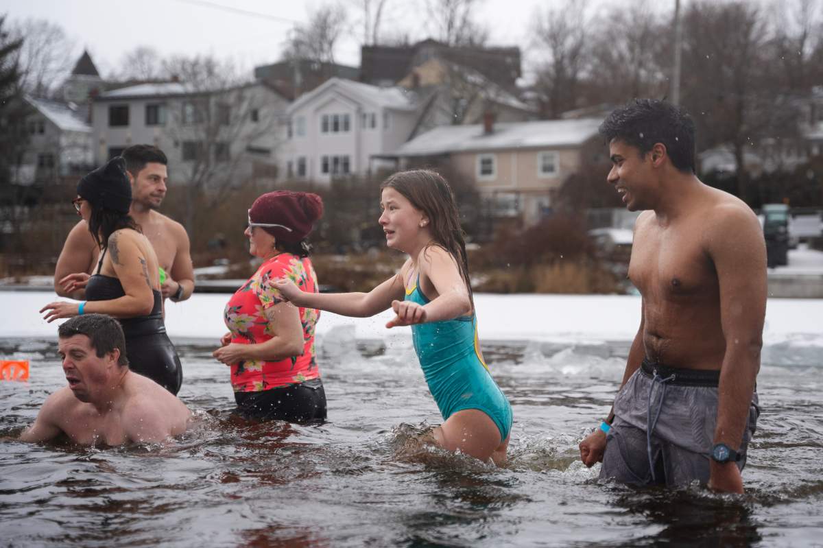 People react to entering the ice-filled water in Lake Banook during the annual polar bear swim on New Year’s Day in Dartmouth, N.S., Thursday, Jan. 1, 2026. THE CANADIAN PRESS/Darren Calabrese