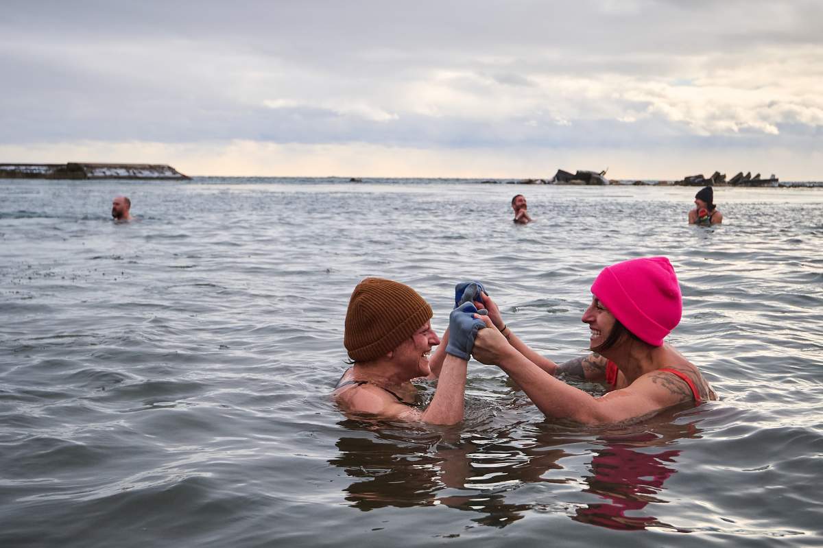 People take part in a New Year’s Day polar bear dip at Sunnyside beach in Toronto, on Thursday, Jan. 1, 2026. THE CANADIAN PRESS/Sammy Kogan