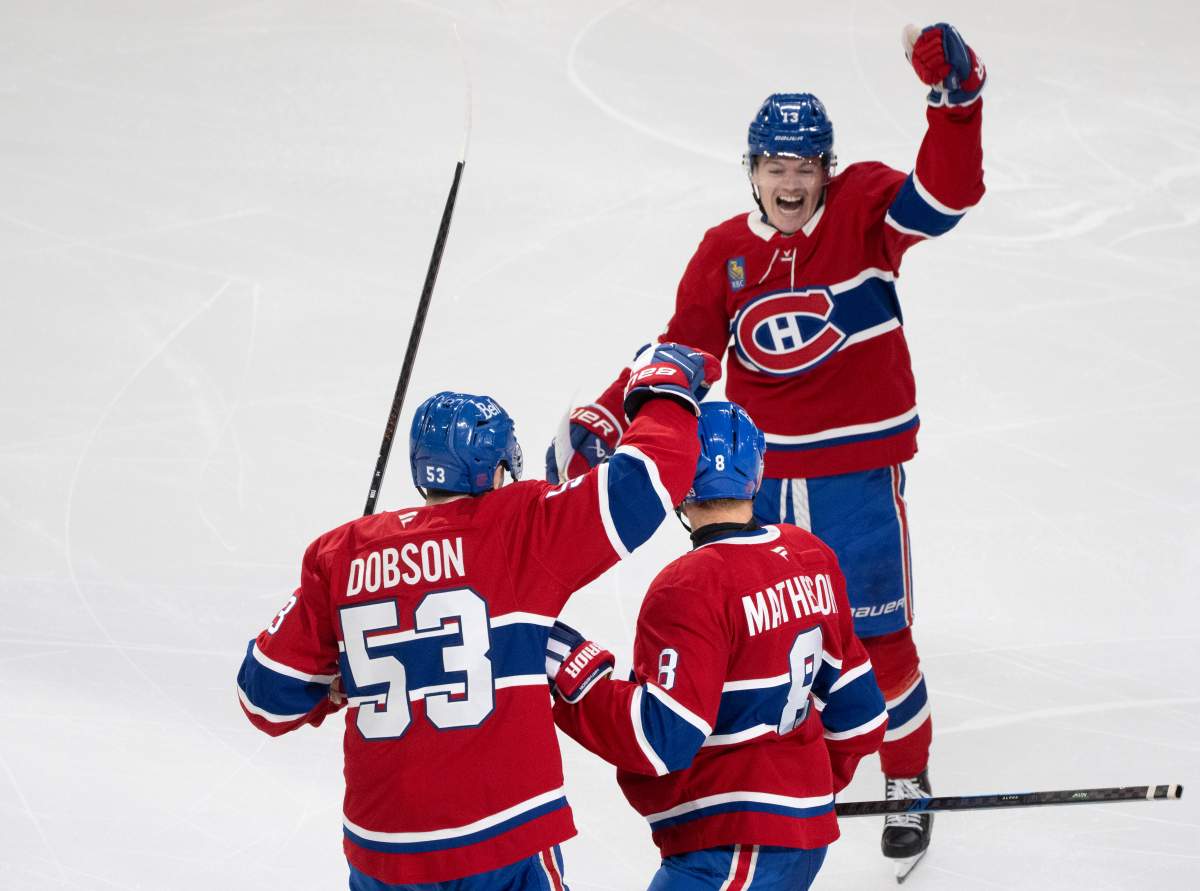 Montreal Canadiens’ Mike Matheson (8) celebrates his goal over Vancouver Canucks with teammates Noah Dobson (53) and Cole Caufield (13) during third period NHL hockey action in Montreal on Monday, Jan. 12, 2026.