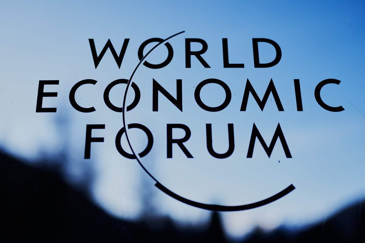 The logo of the World Economy Forum is displayed on a window of the Congress Center where the Annual Meeting Forum take place in Davos, Switzerland, Monday, Jan. 19, 2026. (AP Photo/Markus Schreiber).
