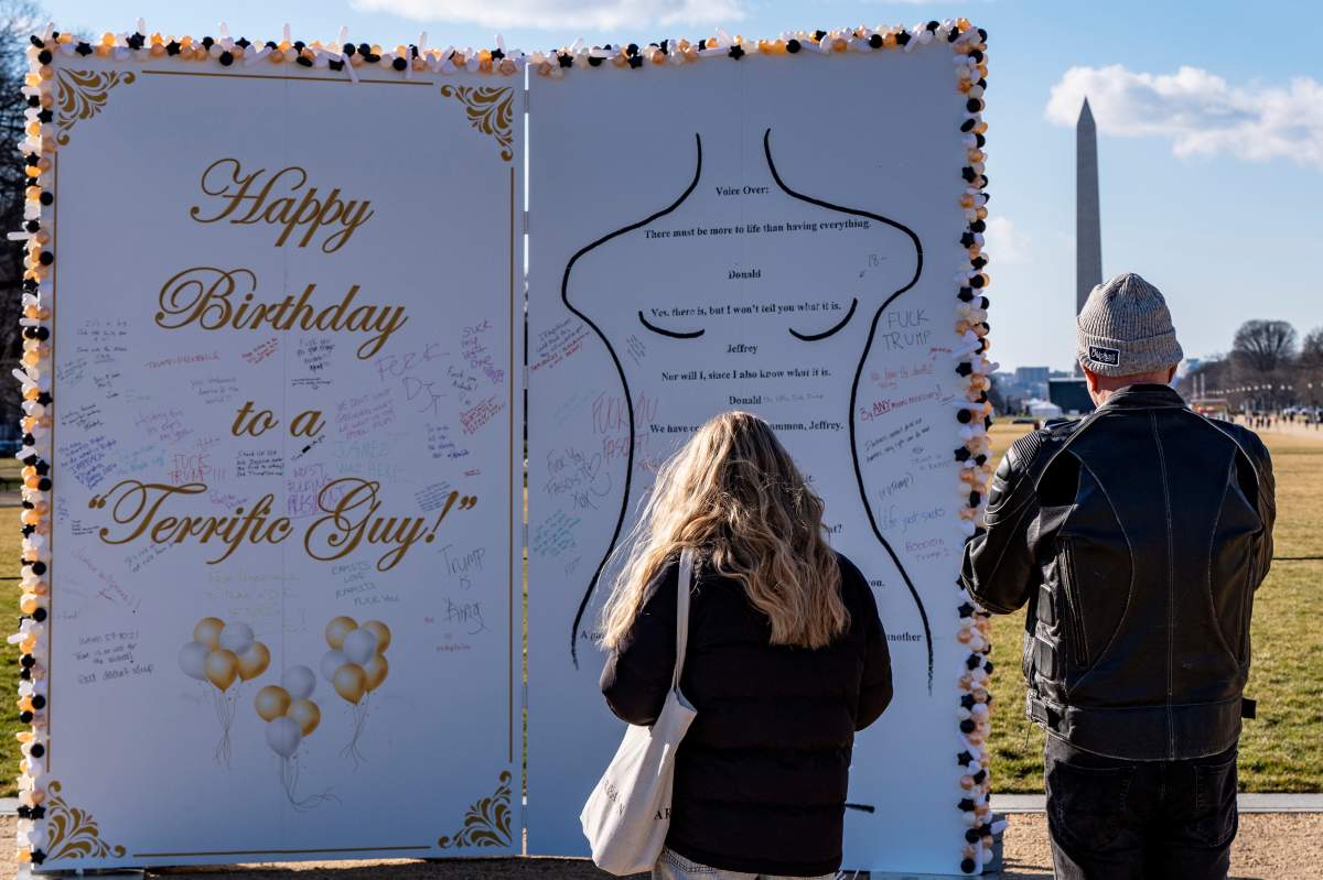 People look at a protest art installation to highlight Jeffrey Epstein's birthday of Jan. 20, 1953, on the National Mall, Monday, Jan. 19, 2026, in Washington.