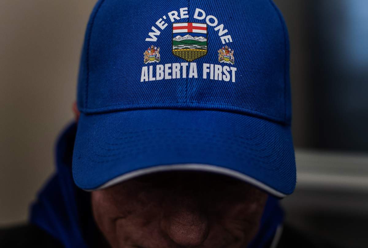 A person wears an Alberta First hat while taking part in signing a petition that seeks to have a referendum on Alberta separation in Stony Plain, Alta., Thursday, Jan. 22, 2026.