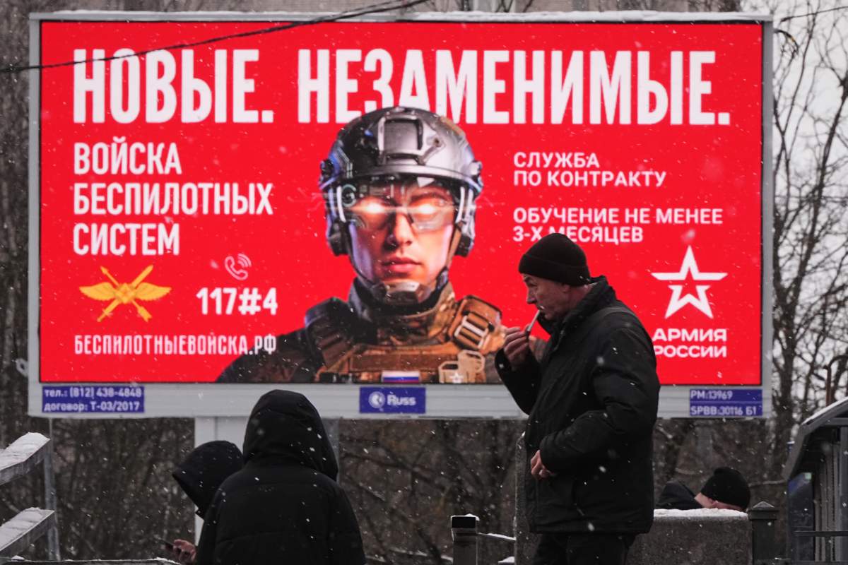 FILE-- A billboard advertises work with the Russian military, which reads in Russian: "New. Irreplaceable', in St. Petersburg, Russia, Friday, Jan. 23, 2026.