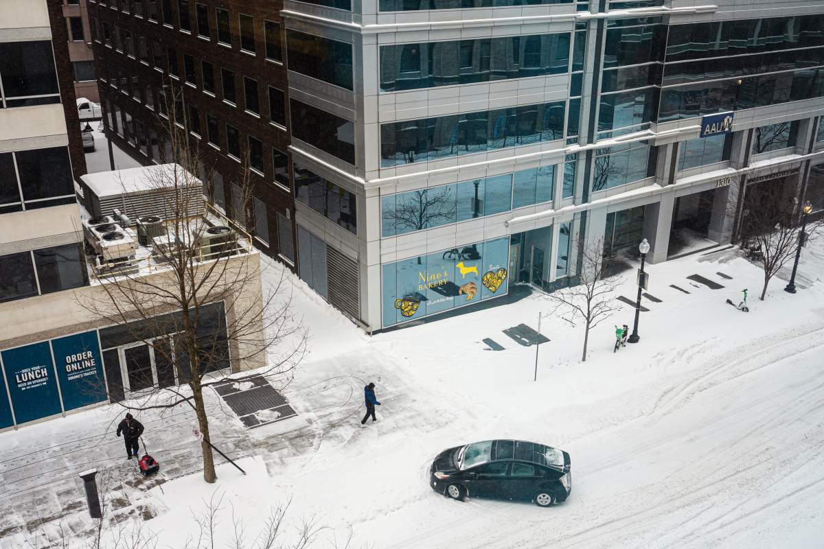 A car is stranded during a snowstorm, Sunday, Jan. 25, 2026, in Washington.