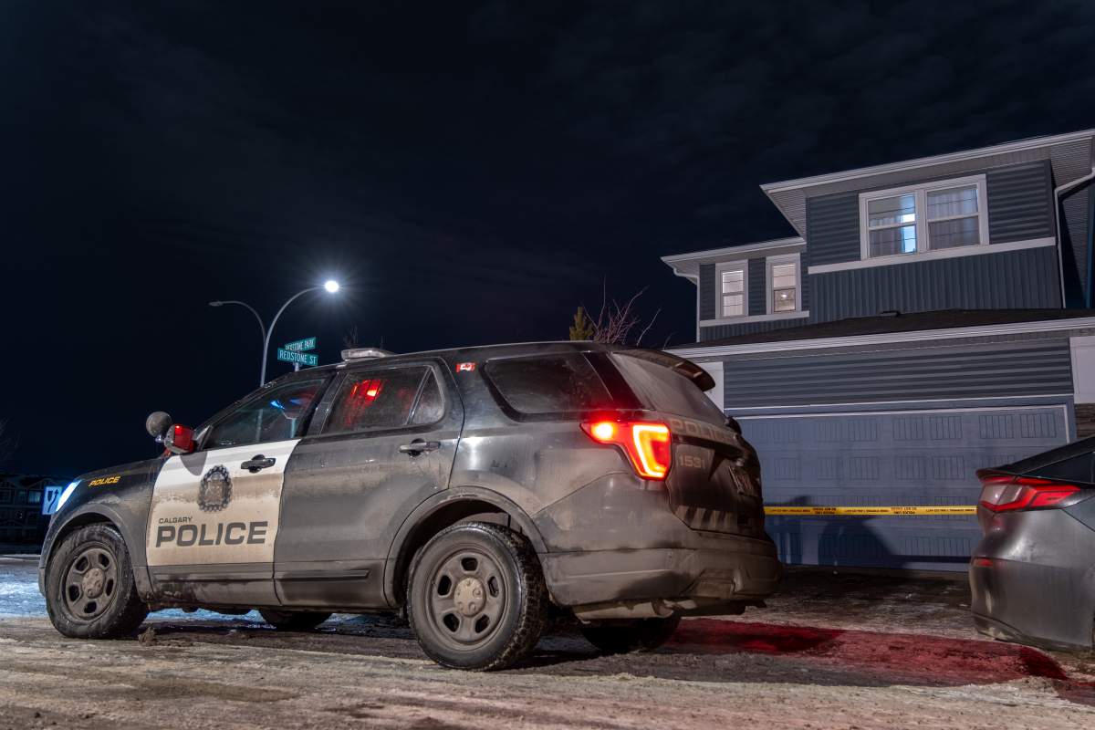 A Calgary Police patrol vehicle is parked outside a home