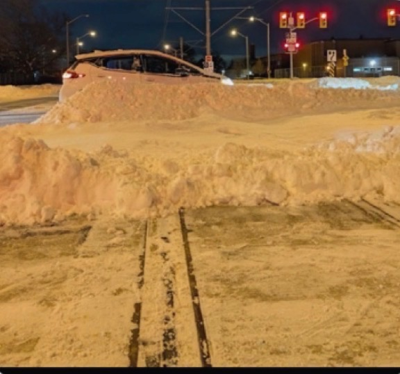 A windrow blocks the rails on Finch West LRT on Friday morning.