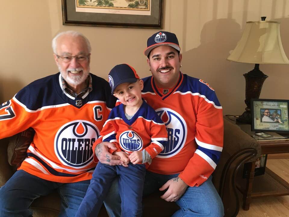Dante Timleck sits between his grandfather, Ralph, and his father, Chris.