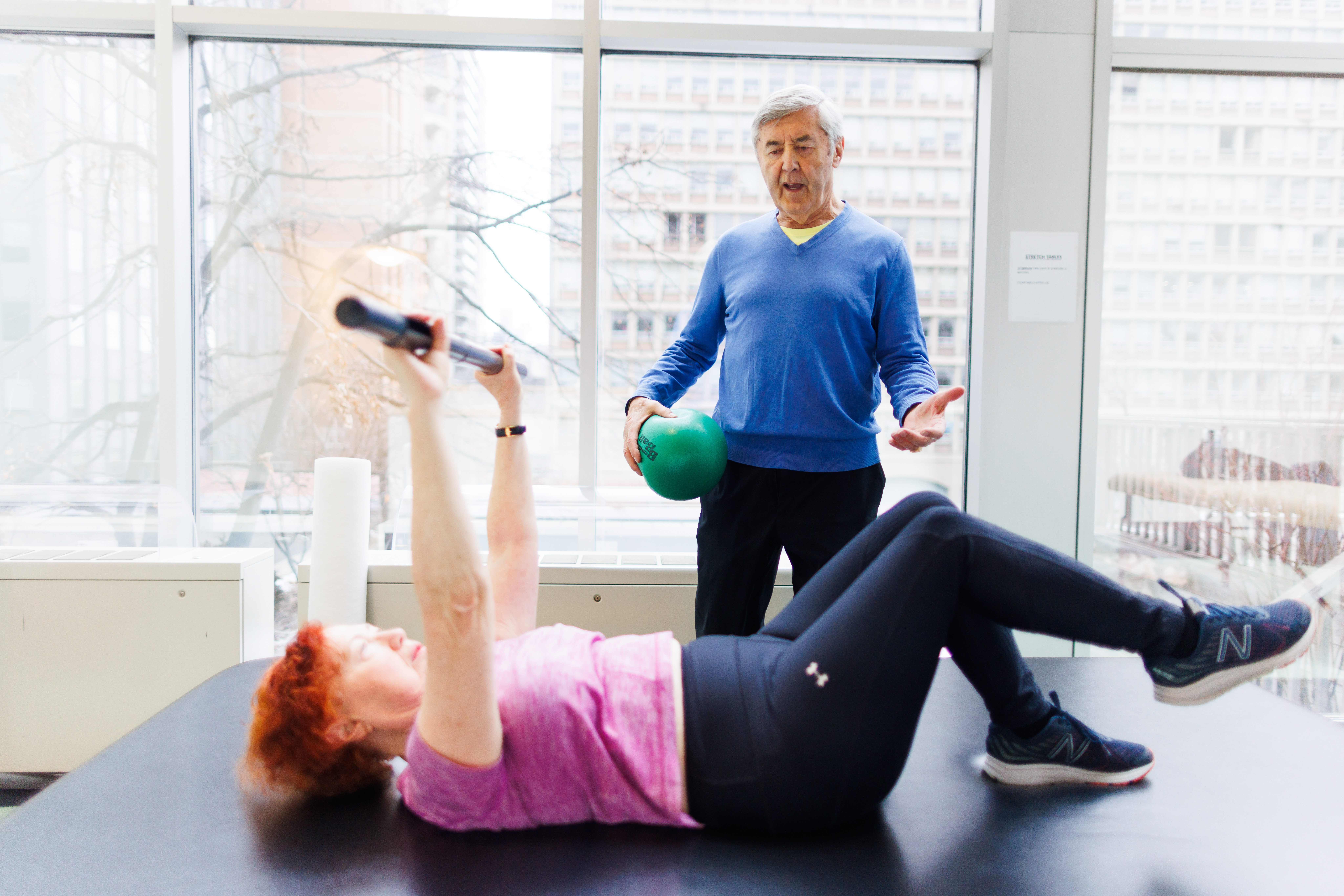 Personal trainer Bob Bursach, 82, works with his client, Miriam Varadi during a fitness session in Toronto on Friday, January 24, 2025.