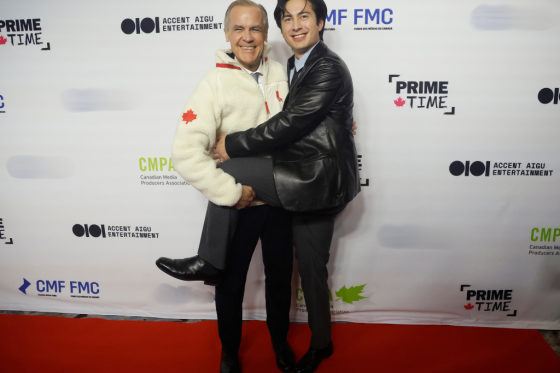 Prime Minister Mark Carney poses for a photo on the red carpet with Hudson Williams, star of the TV series "Heated Rivalry" at the Prime Time screen and media industry conference gala in Ottawa, on Thursday, January 29, 2026.