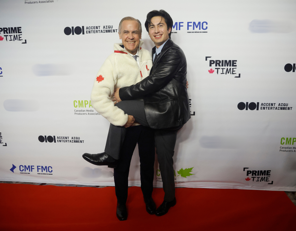 Prime Minister Mark Carney poses for a photo on the red carpet with Hudson Williams, star of the TV series "Heated Rivalry" at the Prime Time screen and media industry conference gala in Ottawa, on Thursday, January 29, 2026.