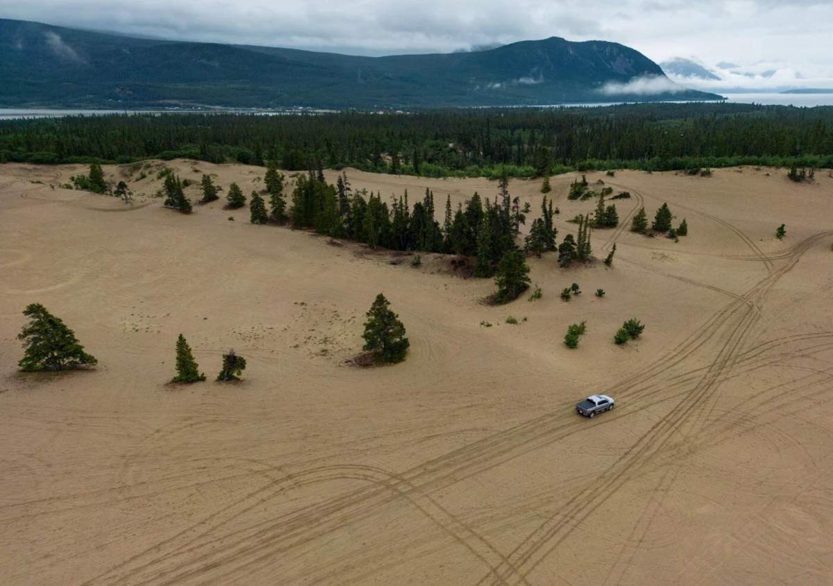 A person drives a truck across the Carcross Dunes in Carcross, Yukon, on Friday, July 25, 2025. 