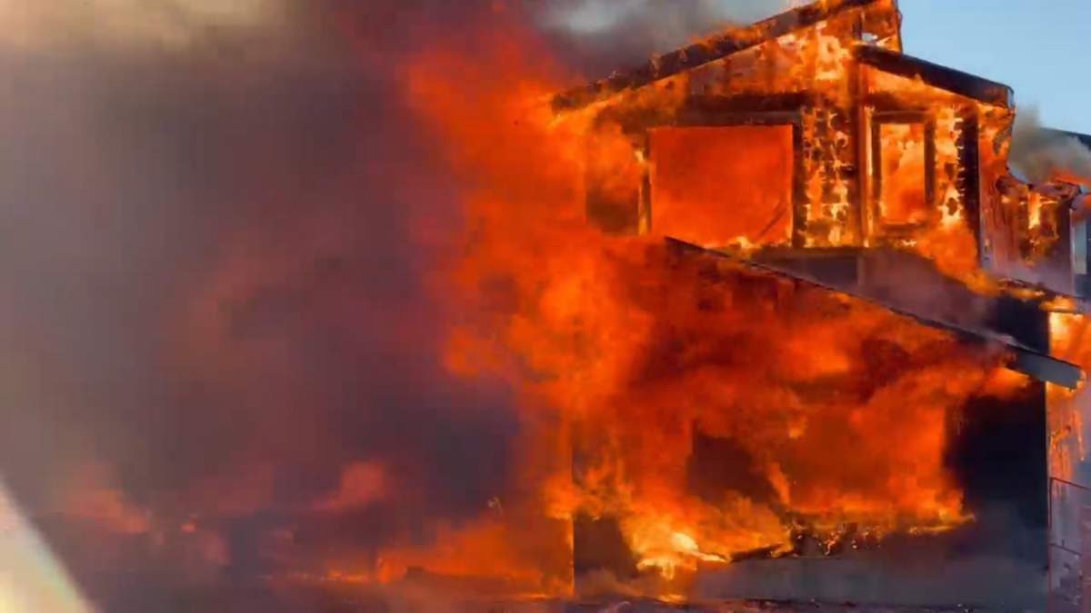 The house, which was under construction in Conrich, just east of Calgary, was fully engulfed by the Thursday afternoon fire.
