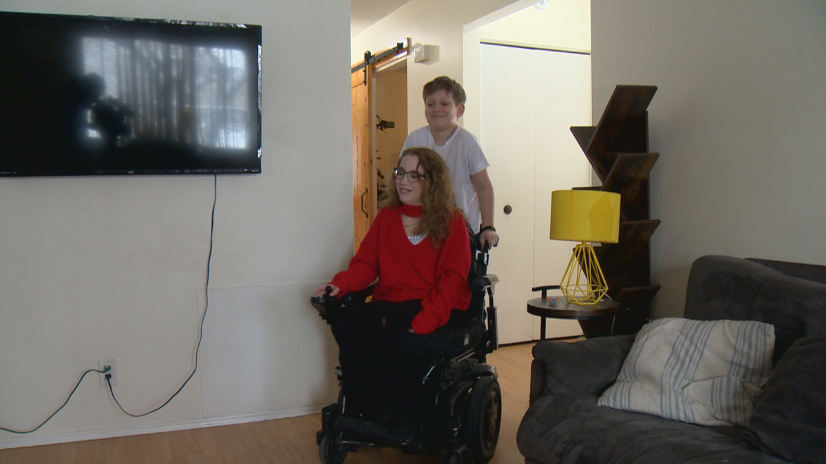 Jocelyn and her son roll through their home.