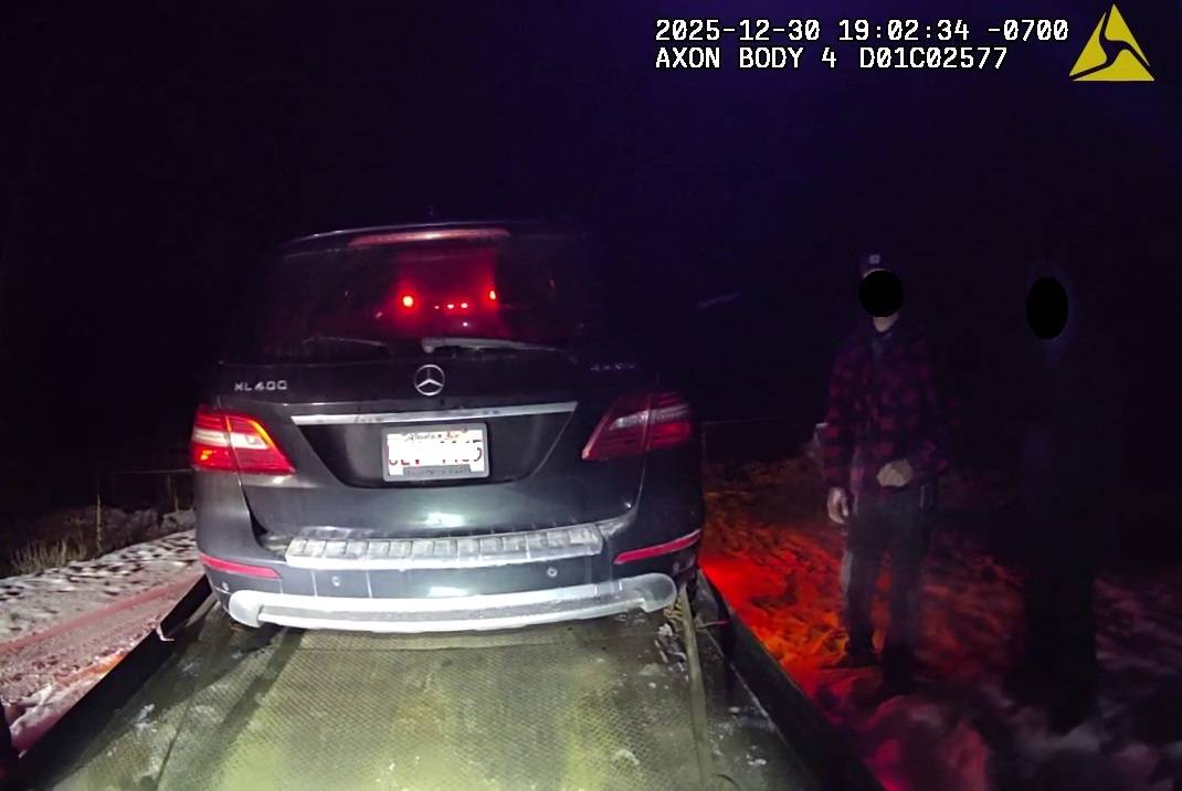 The Alberta owner of a Mercedes SUV watches as his vehicle is loaded onto a tow truck after he was caught speeding 60 km/h above the speed limit on B.C. Highway 3/95 near Moyie on Dec. 30, 2025.