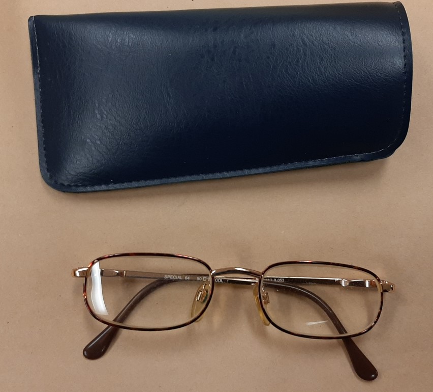 A photo of the man's reading glasses and case that were found in 1999.