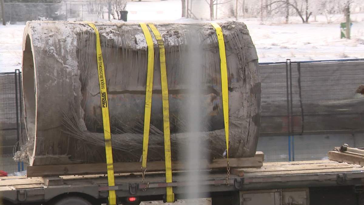 The section of the Bearspaw Feeder Main that ruptured is seen being hauled away by truck as city crews scrambled to make emergency repairs by installing a new section of steel pipe.