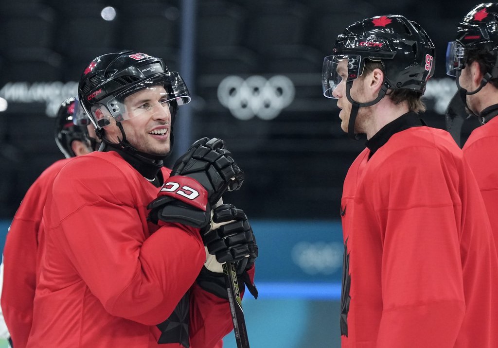 Team Canada captain Sidney Crosby, left, talks with forward Connor McDavid as they take part in practice during the 2026 Milan Cortina Winter Olympics in Milan, Italy on Sunday, Feb. 8, 2026. THE CANADIAN PRESS/Nathan Denette.