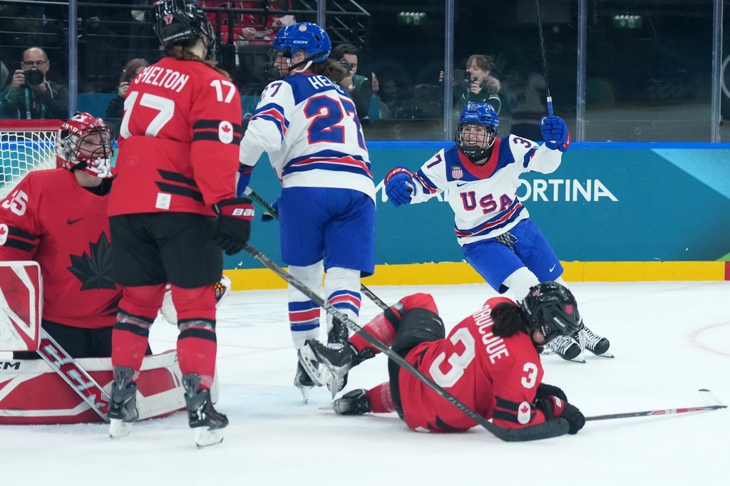 Abbey Murphy (37) of Team United States celebrates after a goal as Team Canada players look on during second period Olympic hockey action at the 2026 Milan Cortina Winter Olympics in Milan, Italy on Tuesday, Feb. 10, 2026. THE CANADIAN PRESS/Nathan Denette.