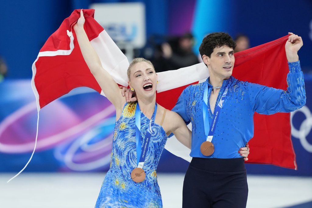 Piper Gilles and Paul Poirier of Team Canada celebrate their bronze medal in the Figure Skating Ice Dance competition during the 2026 Milan Cortina Winter Olympics in Milan, Italy on Wednesday, Feb. 11, 2026. THE CANADIAN PRESS/Nathan Denette.
