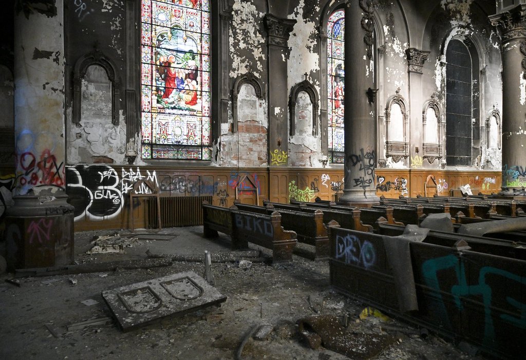 Broken pews, graffiti and debris are seen inside Saint-Eusebe-de-Verceil church in Montreal, Thursday, Feb. 5, 2026. THE CANADIAN PRESS/Graham Hughes.
