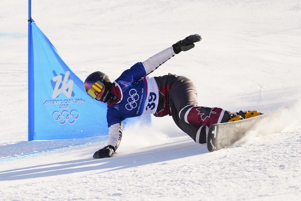 Ben Heldman, from Toronto, Ont., races in the men's snowboarding parallel giant slalom qualification at the Milano Cortina 2026 Winter Olympic Games in Livigno, Italy on Sunday, Feb. 8, 2026. THE CANADIAN PRESS/Sean Kilpatrick.