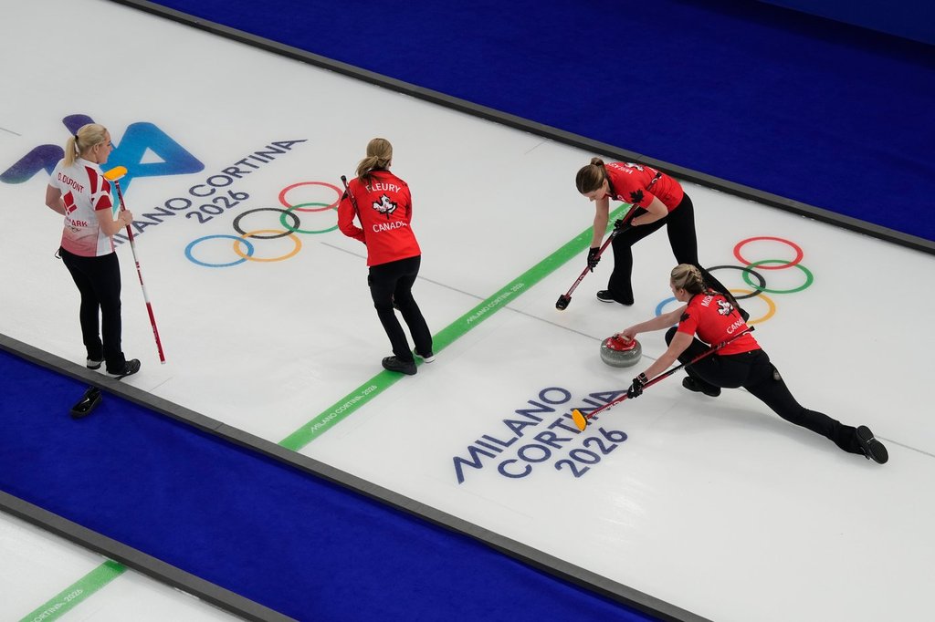 Canada's Emma Miskew, Sarah Wilkes and Tracy Fleury compete against Denmark during a women's curling round robin session at the 2026 Winter Olympics, in Cortina d'Ampezzo, Italy, Thursday, Feb. 12, 2026. (AP Photo/David J. Phillip).
