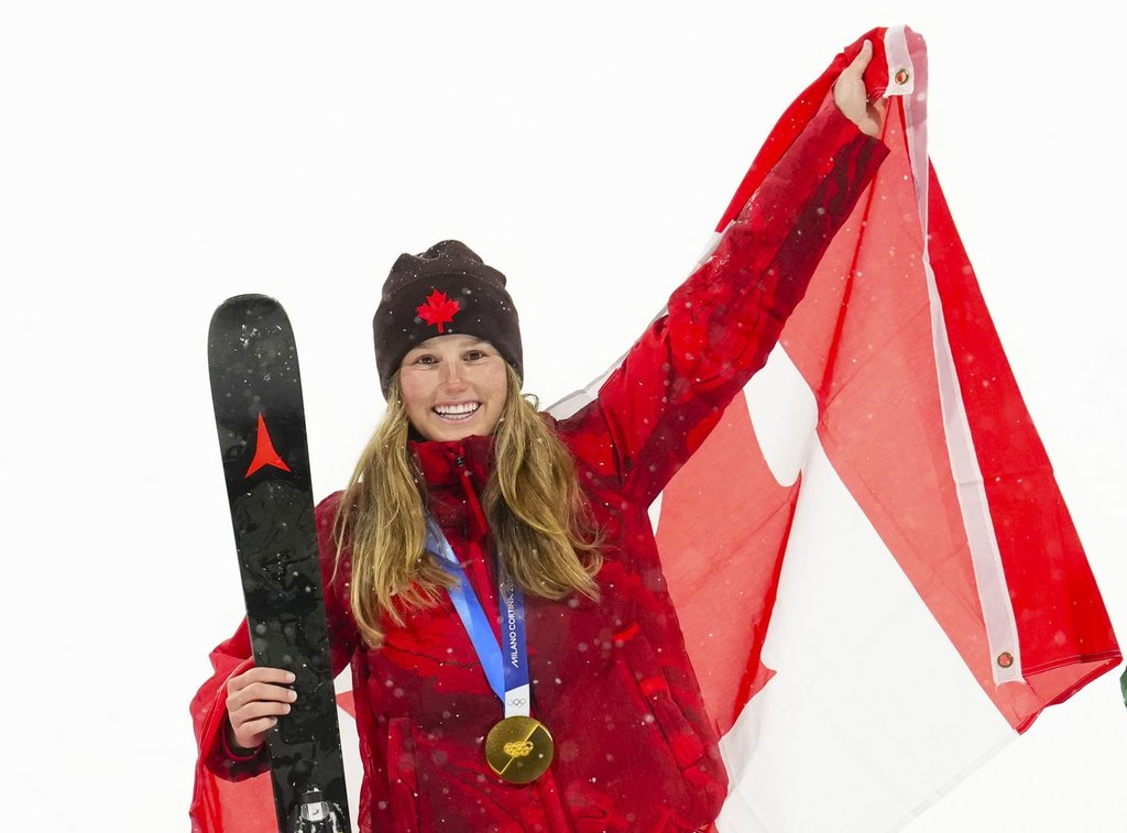 Canada's Megan Oldham (4), back, celebrates her gold medal win in the women's freeski big air final at the Milan Cortina 2026 Winter Olympic Games in Livigno, Italy on Monday, Feb. 16, 2026. THE CANADIAN PRESS/Sean Kilpatrick.