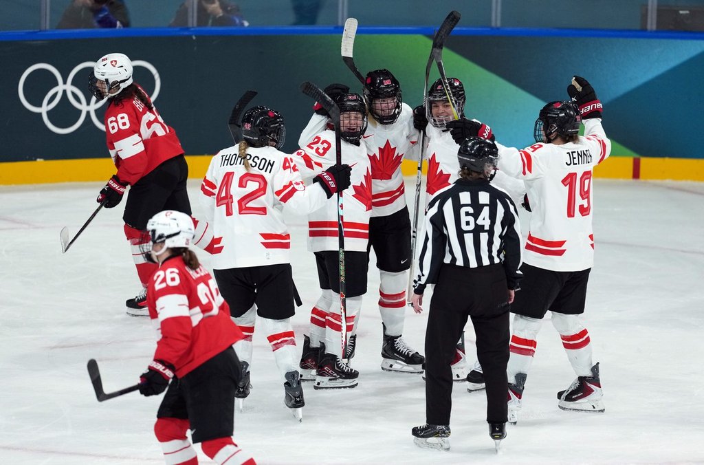 Canada’s Claire Thompson (42), Erin Ambrose (23), Julia Gosling (88), Sophie Jaques (2) and  Brianne Jenner (19) celebrate Canada’s Brianne Jenner's goal against Switzerland during the third period of a preliminary round women's hockey game at the Milan Cortina Winter Olympics, in Milan, on Saturday, Feb. 7, 2026. THE CANADIAN PRESS/Darryl Dyck.
