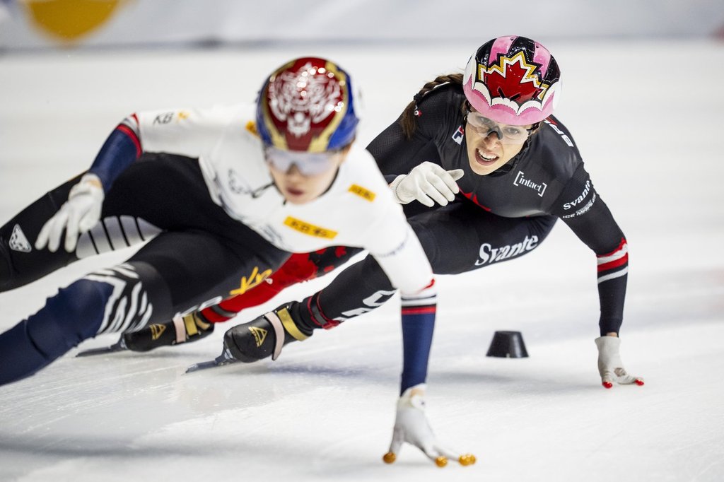 Florence Brunelle of Canada chases Sukhee Shim of Korea during the 3000m relay race at the ISU Short Track World Tour speed skating event in Montreal on Saturday, Oct. 18, 2025. THE CANADIAN PRESS/Christopher Katsarov.