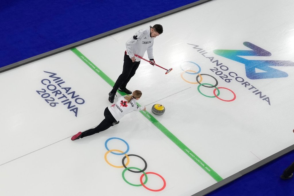 Canada's Brett Gallant and Jocelyn Peterman compete against Switzerland during a curling mixed doubles session at the 2026 Winter Olympics in Cortina d'Ampezzo, Italy on Feb. 9, 2026. (AP Photo/David J. Phillip).