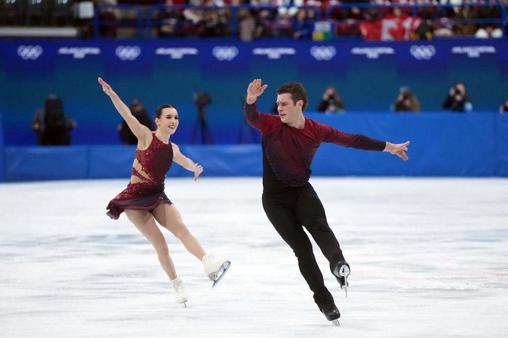 Canada's Lia Pereira and Trennt Michaud compete during the pairs short program figure skating event at the 2026 Winter Olympics, in Milan, on Sunday, Feb. 15, 2026. THE CANADIAN PRESS/Darryl Dyck.