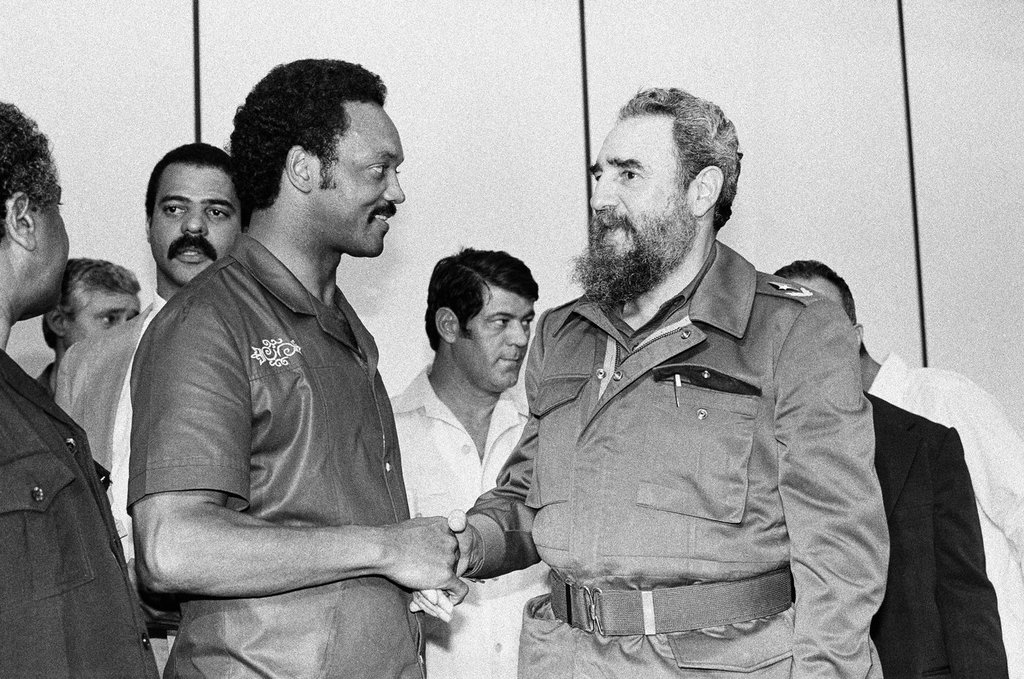 FILE – Democratic Presidential candidate Rev. Jesse Jackson and Cuban President Fidel Castro shake hands following a post-midnight news conference in Havana, Cuba, where the two leaders outlined a plan for improving relations between the U.S. and Cuba, June 7, 1984. (AP Photo/J. Scott Applewhite, File)
