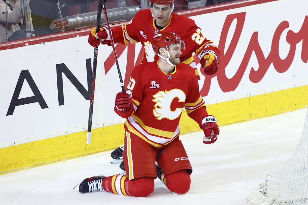 Calgary Flames' Jonathan Huberdeau (10) celebrates his goal with teammate Matt Coronato during first period NHL hockey action against the Anaheim Ducks, in Calgary, Alta., Sunday, Jan. 25, 2026.