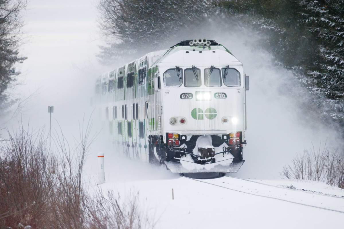 A Toronto-bound GO train kicks up snow at a crossing in Innisfil, Ont., after a large storm blanketed the region on Thursday, Jan. 15, 2026.
