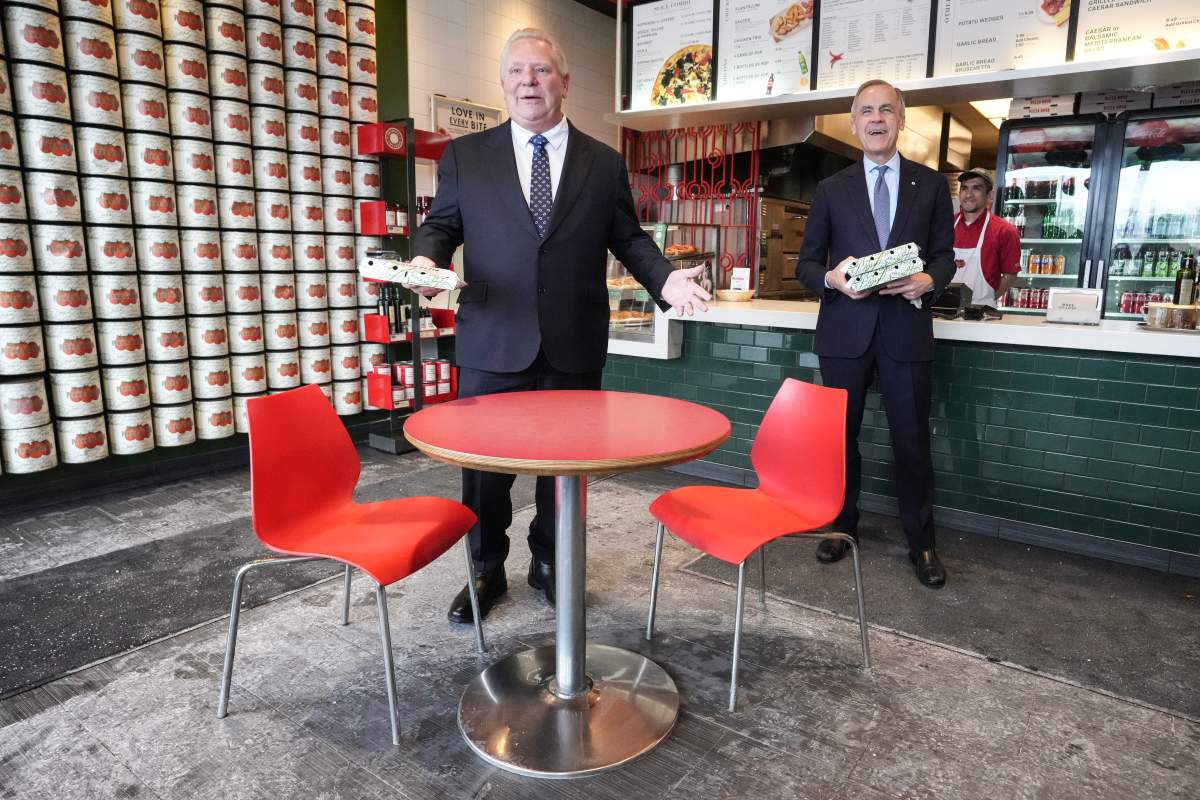 Prime Minister Mark Carney and Ontario Premier Doug Ford speak to the media as they order pizza at a local franchise after their meeting on Monday January 26, 2026. 