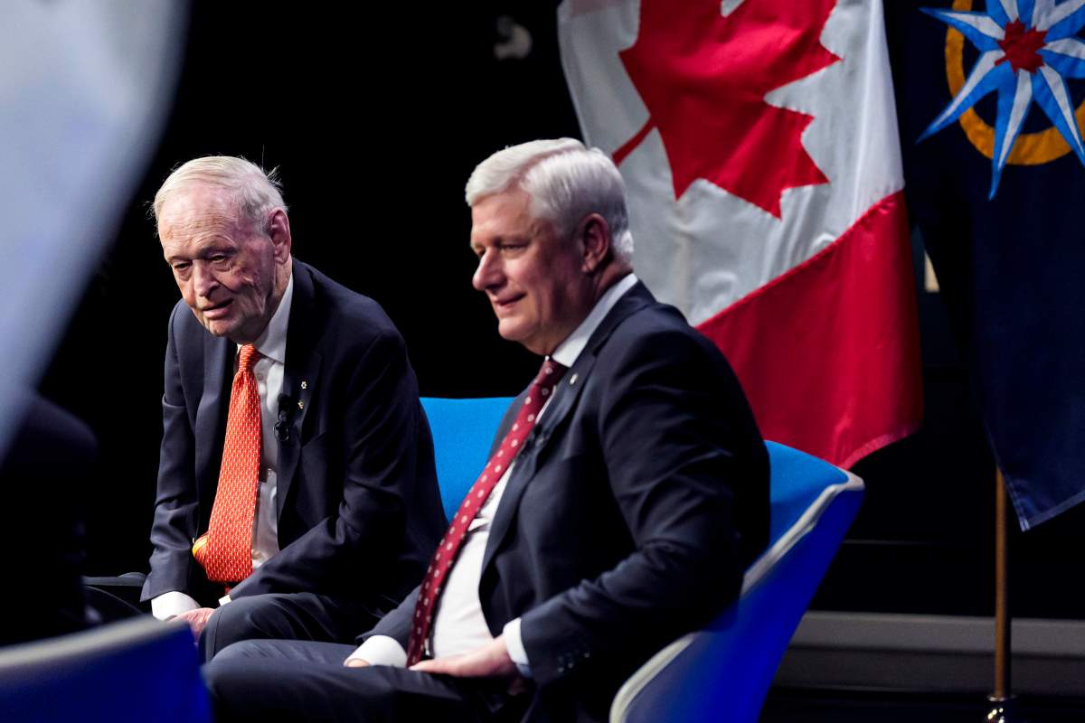 Former prime ministers Jean Chretien, left, and Stephen Harper participate in a panel discussion, after Harper received a gold medal from the Royal Canadian Geographical Society in Ottawa, on Monday, Feb. 2, 2026. THE CANADIAN PRESS/Justin Tang.