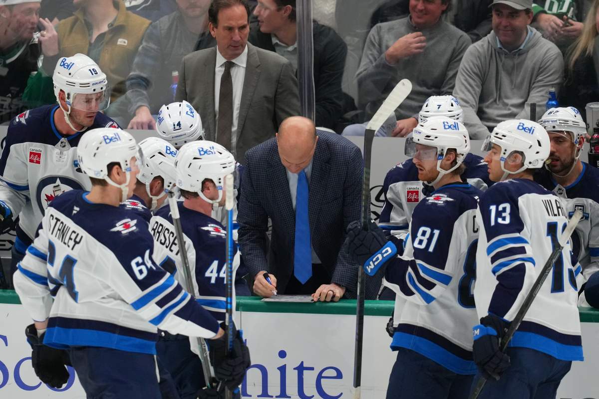 Winnipeg Jets assistant coach Davis Payne, centre, draws up a play during a timeout in the third period of an NHL hockey game against the Dallas Stars Monday, Feb. 2, 2026, in Dallas.