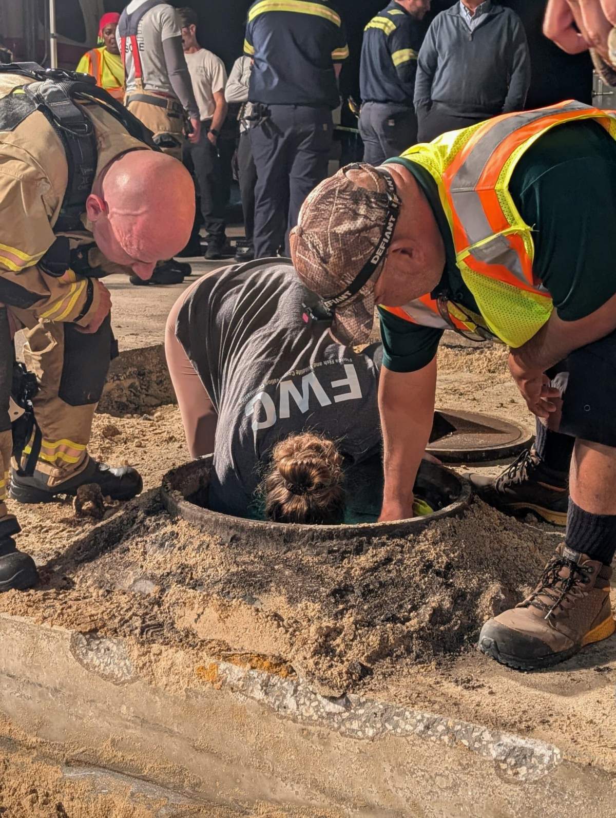 This photo provided by Brevard County Fire Rescue shows members of Brevard County Fire Rescue help rescue a manatee that was stuck in a storm drain on Monday, Feb. 9, 2026 in Melbourne Beach, Fla.