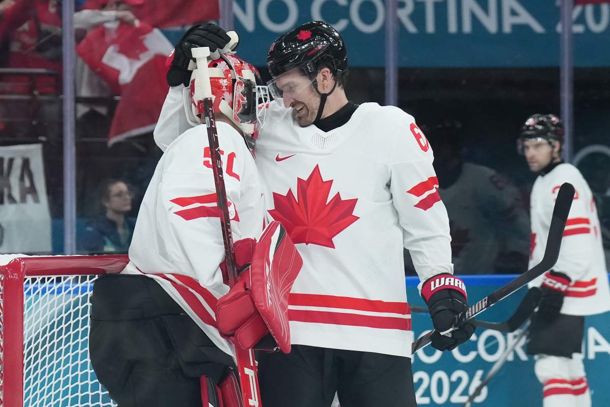 Mark Stone (61) of Team Canada celebrates with Jordan Binnington (50) after their 5-0 win over Team Czechia at the end of men's Olympic hockey action at the 2026 Milan Cortina Winter Olympics in Milan, Italy on Thursday, Feb. 12, 2026.