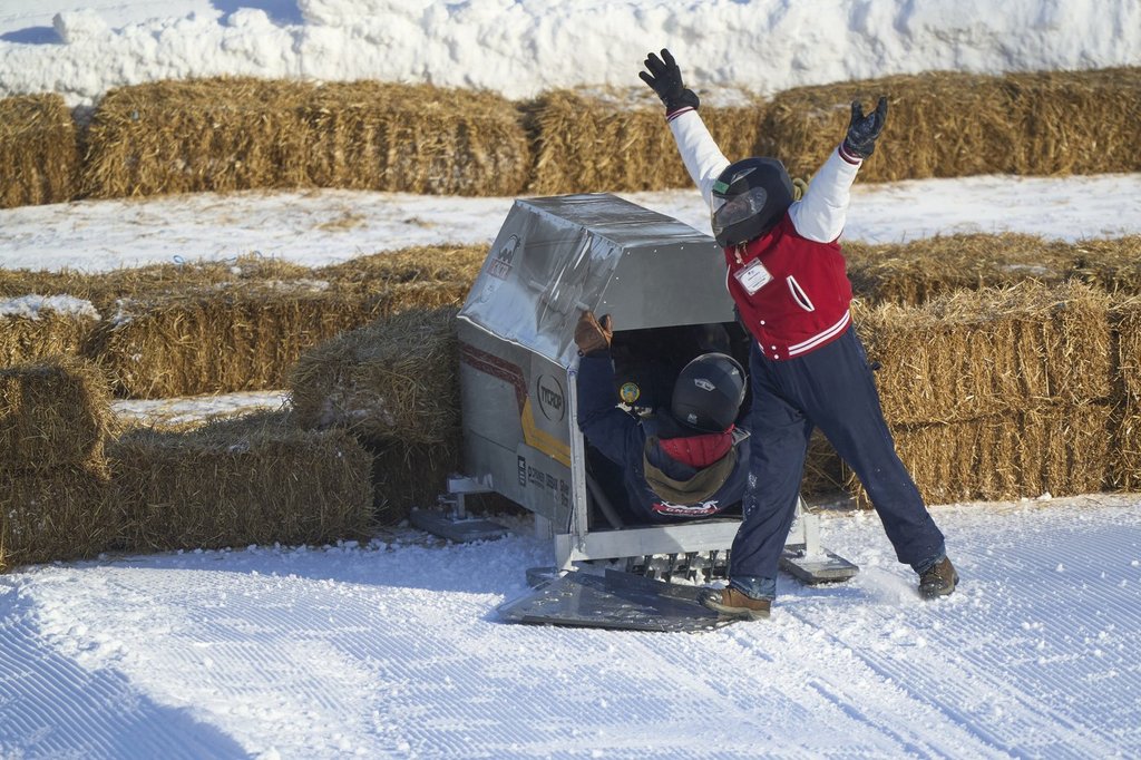 Adeo Kodra of the University of British Columbia Okanagan celebrates after a run at the 2026 Great Northern Concrete Toboggan Race at Boler Mountain in London, Ont. on Saturday, Feb. 7, 2026. The annual competition brings together engineering schools from across Canada to race their toboggans. THE CANADIAN PRESS/ Geoff Robins.