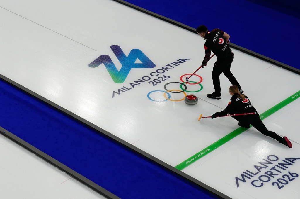 Canada's Jocelyn Peterman and Brett Gallant compete against Sweden during the mixed doubles round robin phase of the curling competition at the 2026 Winter Olympics in Cortina d'Ampezzo, Italy, on Feb. 8, 2026. (AP Photo/Christophe Ena).